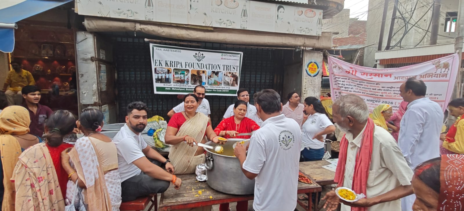 Volunteers serving meals to people during a community seva activity
